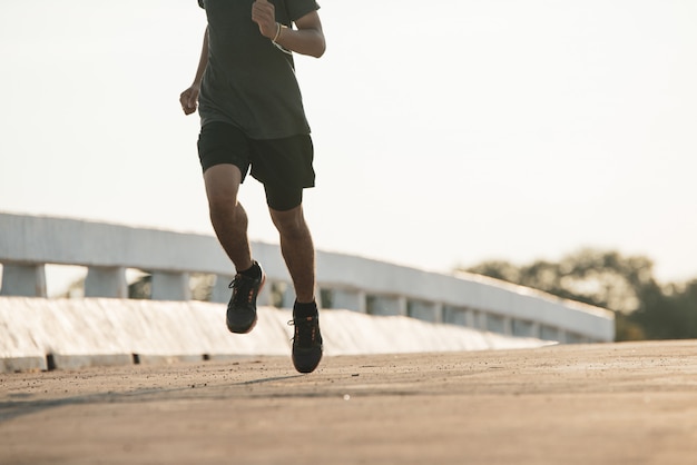 silhouette of a young fitness man running on sunrise