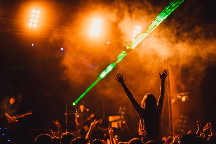 Free Photo silhouette of a young lady in the crowd during concert