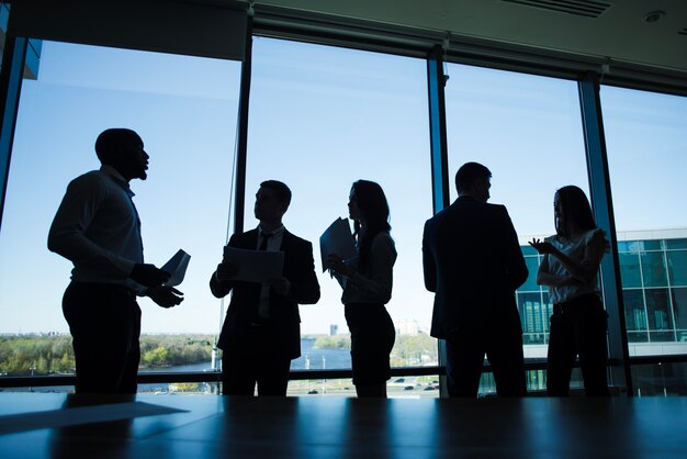 Silhouettes of discussing business people