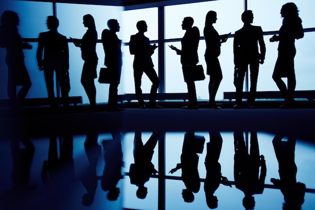 Silhouettes of executives gathered