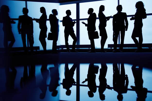 Silhouettes of executives gathered
