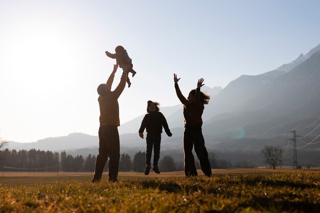 silhouettes of families in nature at sunset