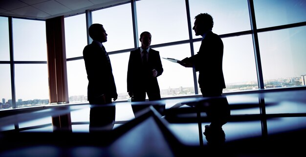 Silhouettes of workers planning a strategy