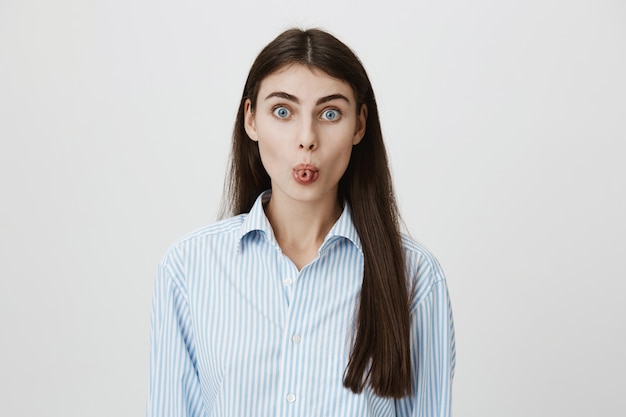 Silly adult woman folding tongue