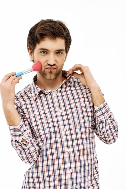 Silly feminine guy touch cheek makeup brush