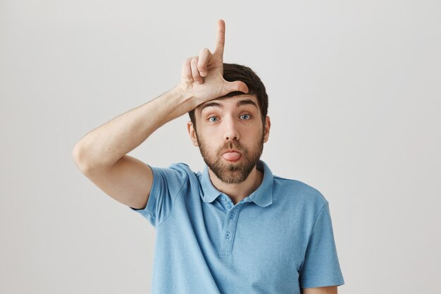 Silly and funny young bearded man posing