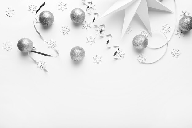 Silver Christmas ornaments on white table