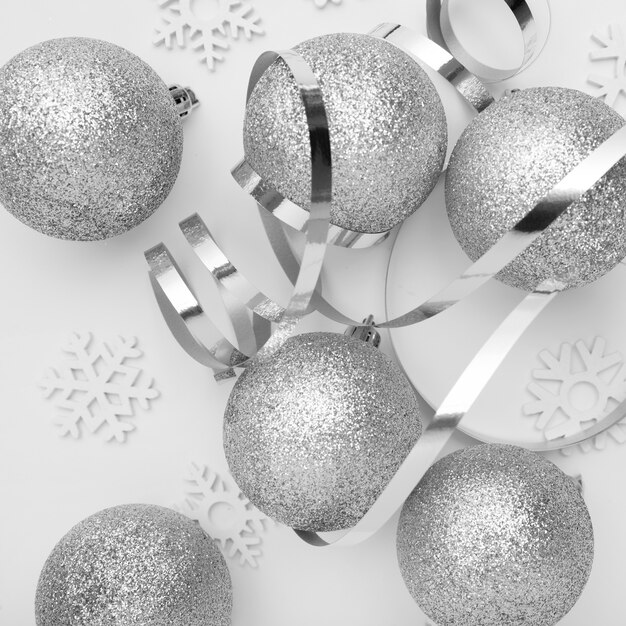 Silver Christmas ornaments on white table