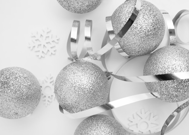 Silver Christmas ornaments on white table