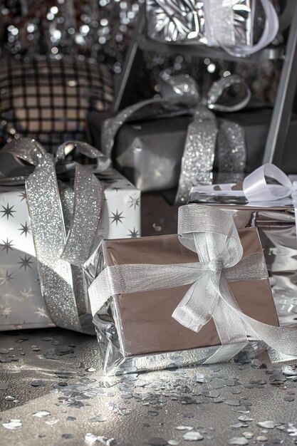 Silver festive christmas boxes on a shiny background