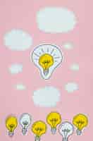 Free photo silver and golden light bulbs idea concept with clouds