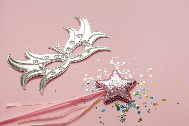 Silver mask with pink star on stick