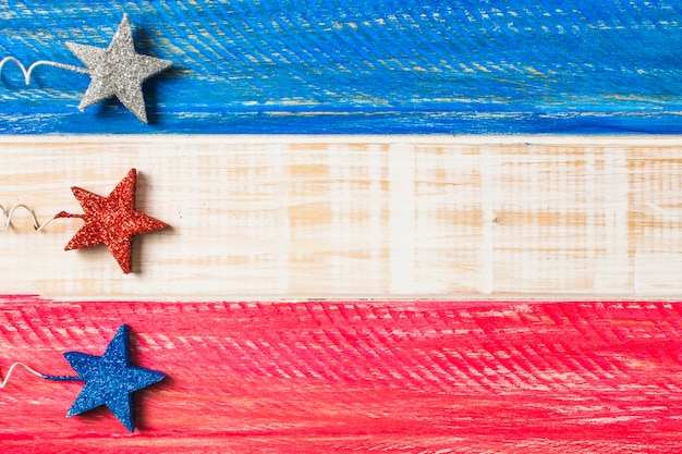 Silver; red and blue decorative stars on painted wooden surface