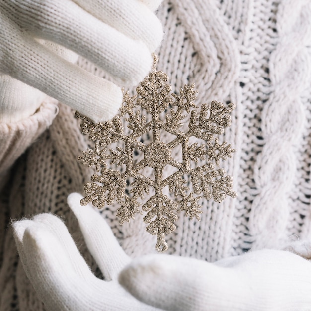 Silver snowflake in hands 