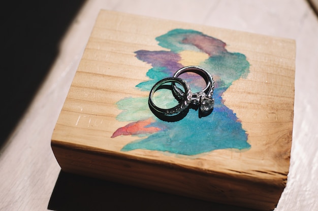 Free photo silver wedding rings lie on the painted box