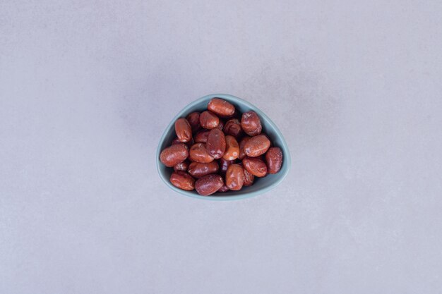 Silverberry fruits in bowl on white.