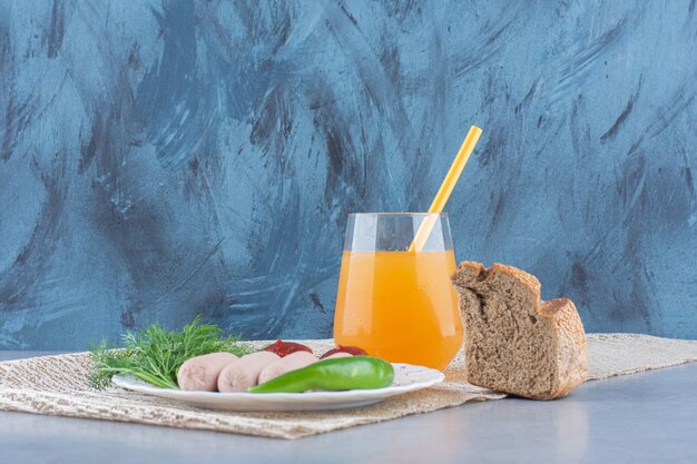 Simple English breakfast. sausage and orange juice with bread. 