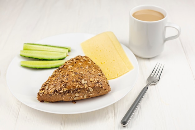 Simple plate with breakfast on white table