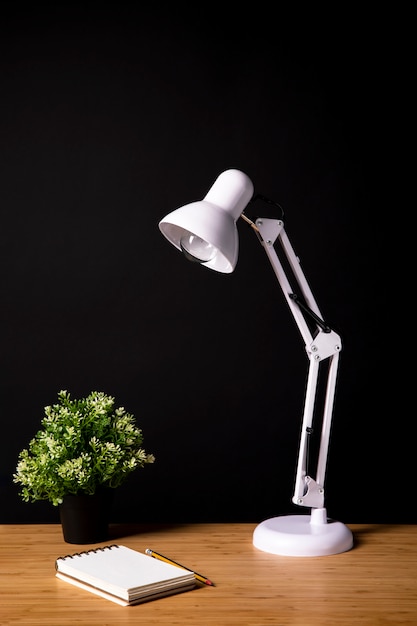 Simple wood desk with lamp and notebook