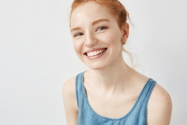 Sincere ginger woman smiling.