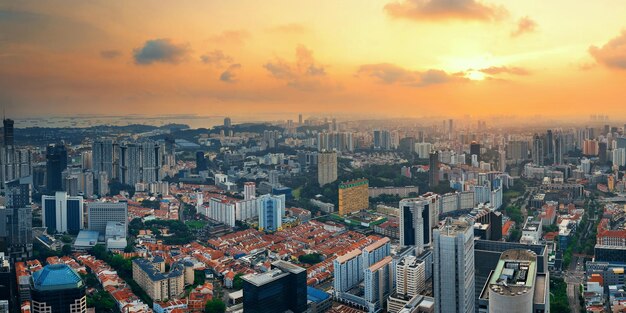 Singapore rooftop view with urban skyscrapers at sunset.