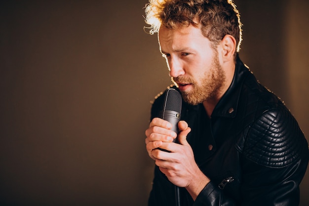 Singer with microphone singing in studio