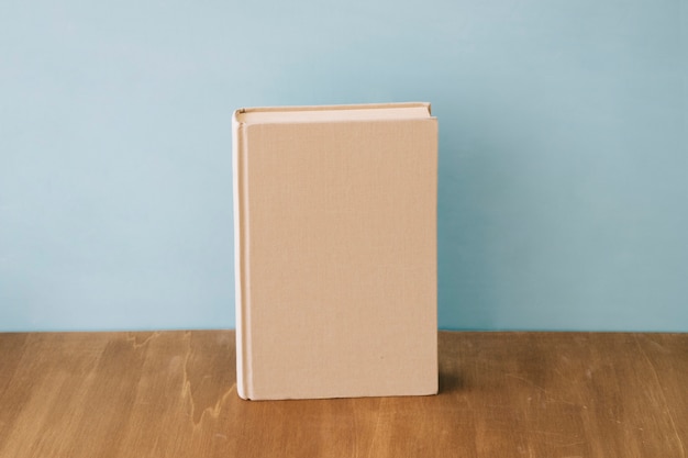 Free photo single book on wooden surface