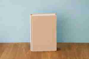 Free photo single book on wooden surface