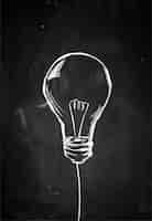Free photo single bulb sketch on blackboard