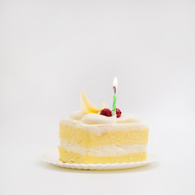 Single candle over the cake slice against white background