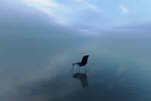 Free photo single chair reflecting on a water surface on a stormy day