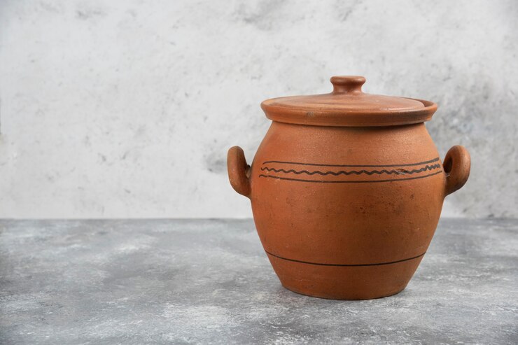Free Photo single clay antique vase placed on marble surface.