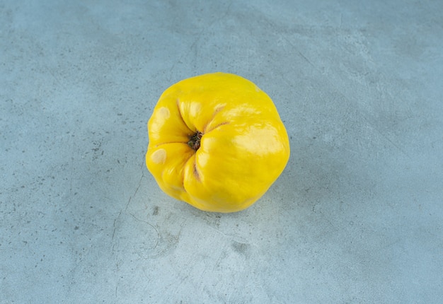 A single of delectable quince, on the marble background. High quality photo