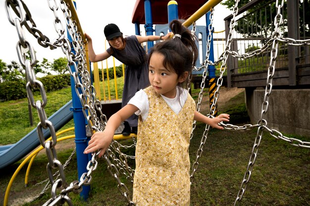 Single mom playing with her daughter in a park