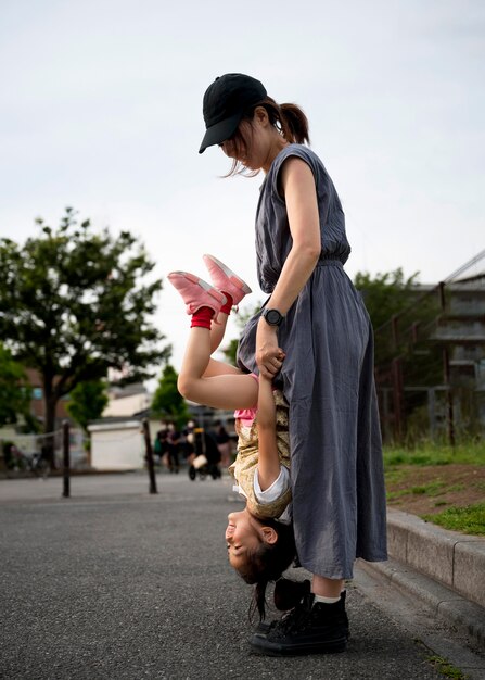 Single mother playing with her daughter in a park
