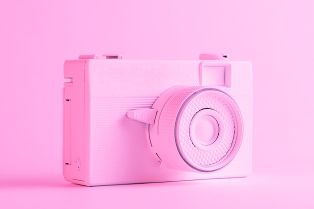 Single painted camera against colored pink backdrop