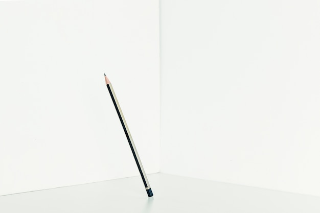 Single pencil in corner of room