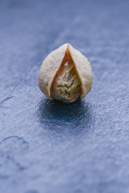 Single Roasted And Salted Pistachio On Dark Background