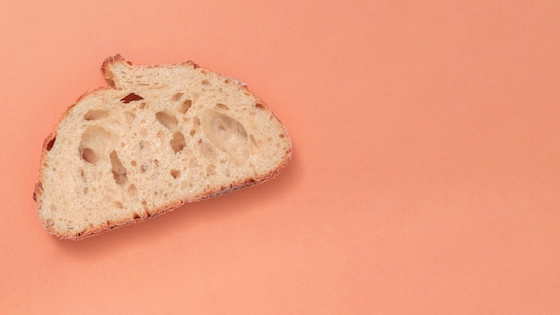 Single slice of bread on colored backdrop