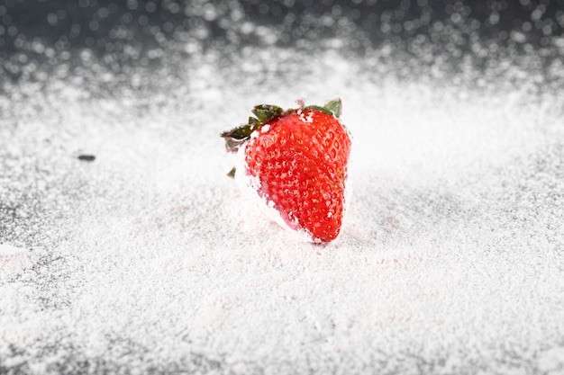 Free photo a single stawberry on the flour