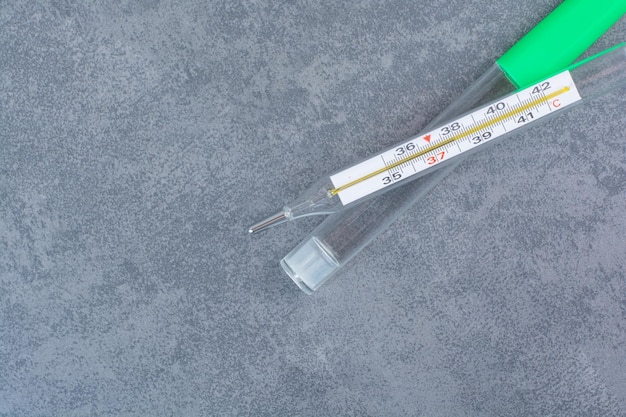 Single thermometer isolated on marble surface