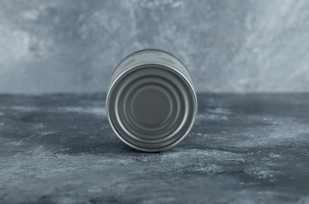 Free photo single tin can placed on marble.
