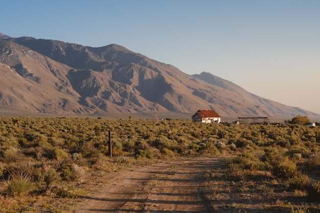 Single white house with a brown roof in California, next to the Sierra Nevada mountains