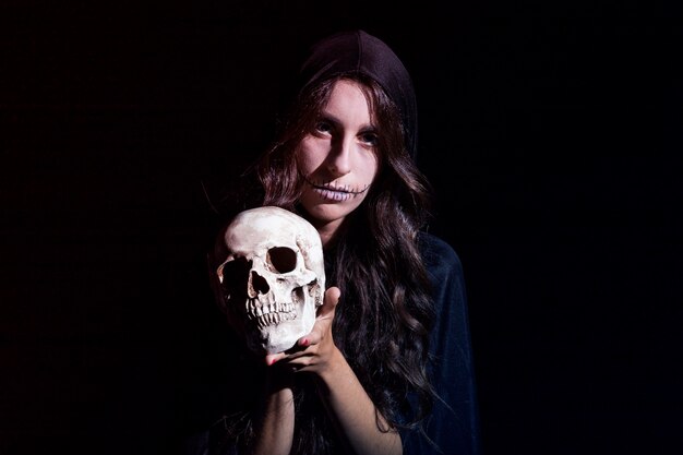 Sinister female with human skull