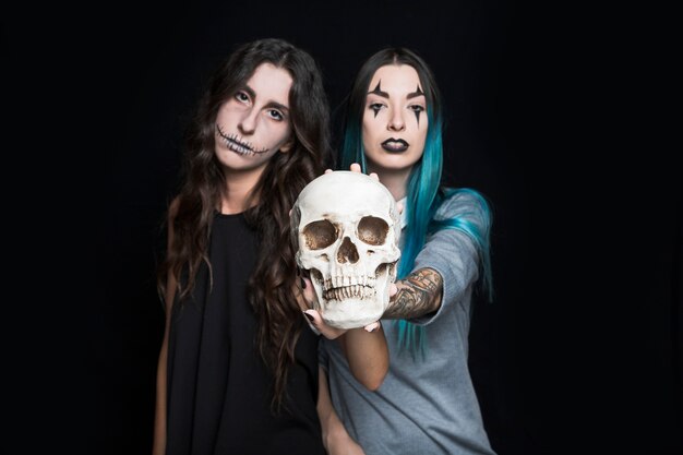 Sinister girls holding skull