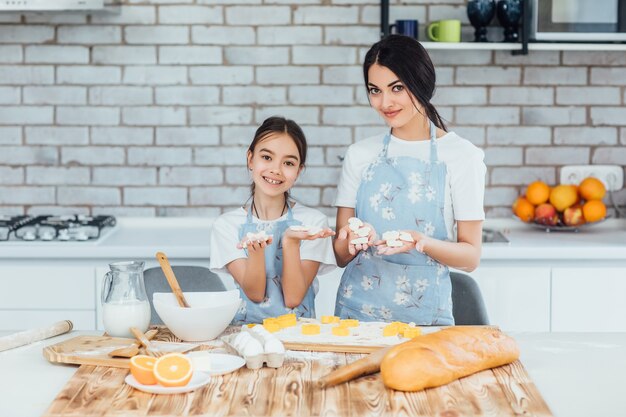 Sister girls cook linzer cookies in the kitchen