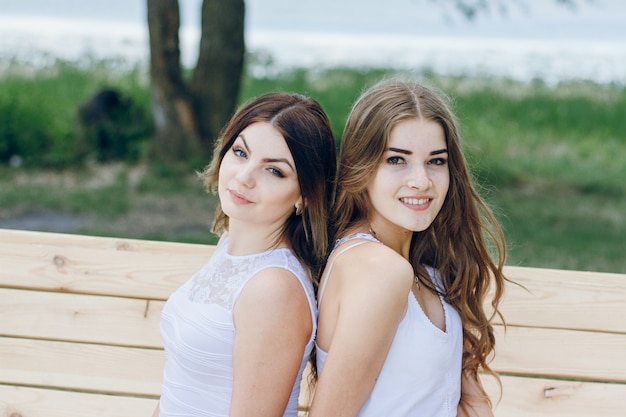 Free photo sisters beach tress one hands