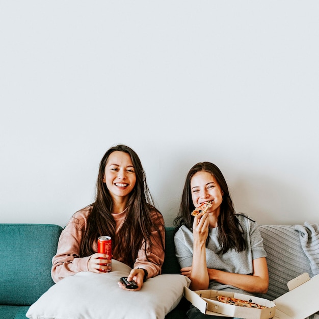 Sisters eating pizza together during coronavirus quarantine