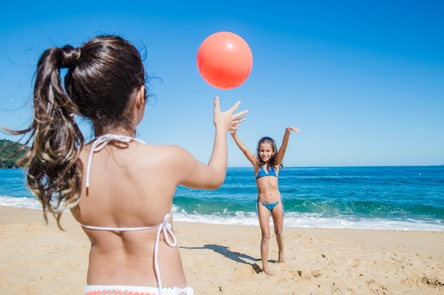 Sisters having fun with a ball