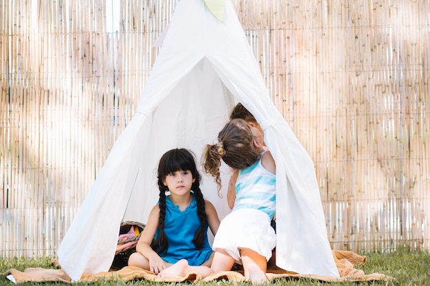 Sisters sitting in tent